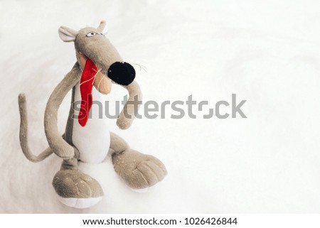 cute plush mouse on the snow
