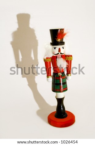 dramatic lighting on a traditional wooden Christmas Nutcracker ornament
