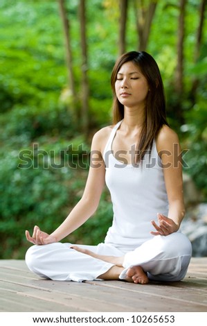 A young woman doing yoga outside in natural environment Royalty-Free Stock Photo #10265653
