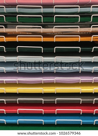 wrought iron shelf, colored papers 
