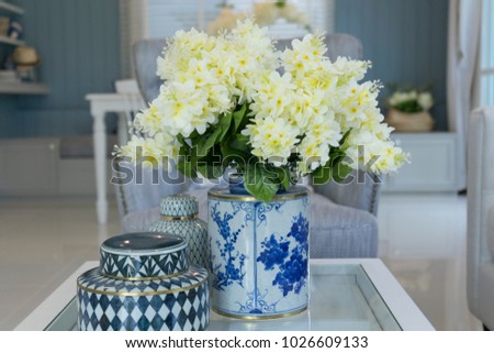 white flower in ceramic vase on table in  living room