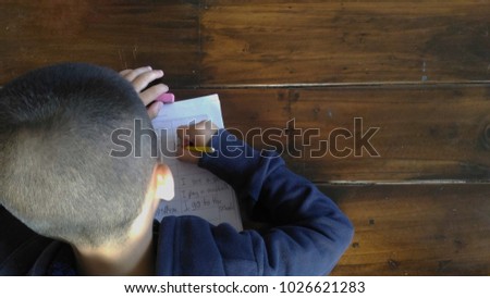 a boy is writing sentences