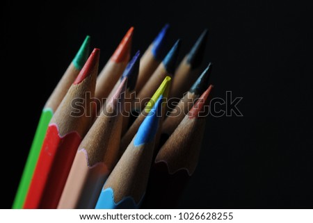 color pencils are arranged and taken dark background image