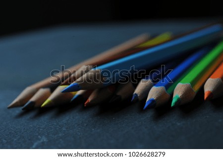 color pencils are arranged and taken dark background image