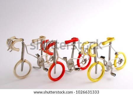 Selective focus picture of handmade bicycle made by aluminium wire and color pipe plastic with isolate white background and copy space, close up soft focus background