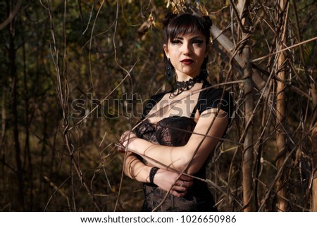 Fashionable stylish beautiful goth girl walk in forest summer day