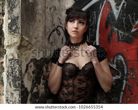 Fashionable stylish beautiful goth girl in old abandoned place summer day