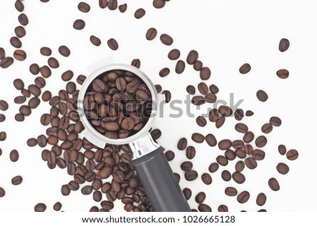handle filled with ground coffee on white background