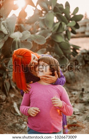 Beautiful family with a red haired mom and her daughter
