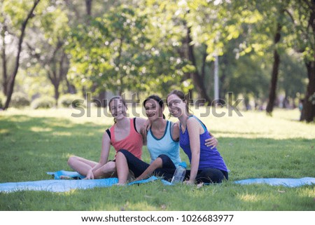 Families with young Russian mother and daughter hugged each other with joy after practicing yoga at the park finished. Health and Fitness concept