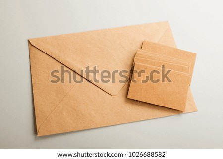 Top view of business cards and envelope of brown color. Copy space. Mockup.