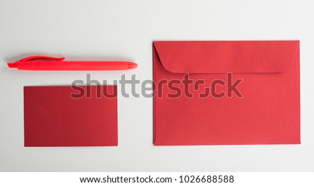 Top view of business card, ballpoint pen and red envelope. Copy space. Mockup.