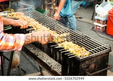 People are cooking food in this picture is  thai grilled pork.