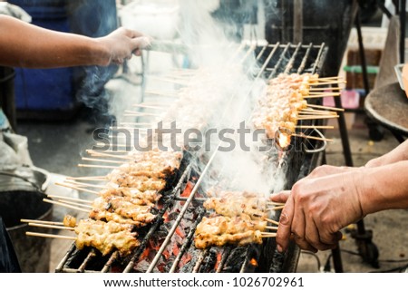 People are cooking food in this picture is  thai grilled pork.