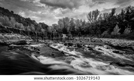 Water flows in many waterfalls and cascades, Black and white panoramic