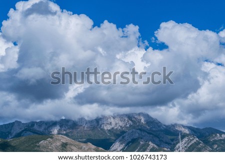 Top of the mountain in the sky, clouds. Landscape in the cloudy day in Bar, Montenegro, Adriatic Sea.  Royalty-Free Stock Photo #1026743173