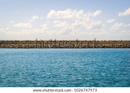 Closer look the stone wall on the sea in Bar marine in Montenegro, Adriatic Sea. Royalty-Free Stock Photo #1026747973