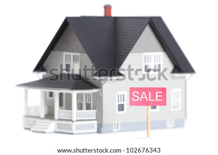 Real estate concept - house architectural model with sale sign, isolated