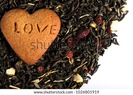 Cookies with the inscription "Love" and dry tea.
