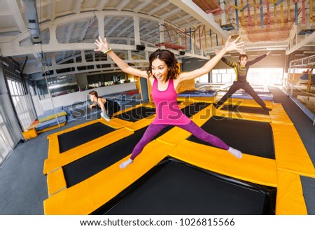 A group of active friends jumping and bouncing on a trampoline, the concept of a youth fitness center Royalty-Free Stock Photo #1026815566