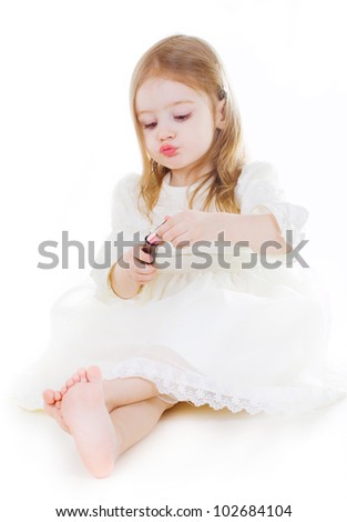 little cute girl with lipstick on white background
