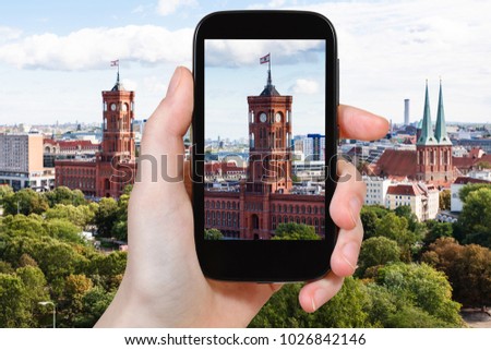 travel concept - tourist photographs Rotes Rathaus (Red City Hall) in Berlin city on smartphone