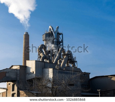 Cement factory pollutes the air near the city Royalty-Free Stock Photo #1026885868