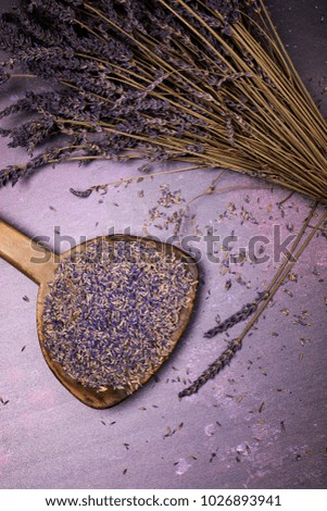 Lavender bouquet with loose sprigs and an old wooden spoon with dried flowers. Flat lay retro style. 