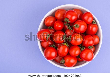 Tomatoes are small fresh ripe red. Studio Photo