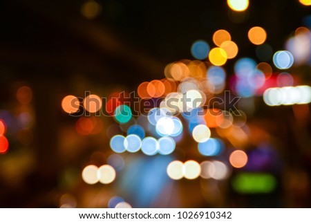 Blurred traffic jam on rainy night. Abstract background of city lights bokeh.