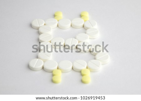 buying drugs with cryptocurrency: bitcoin Sign pictured with pills on white background