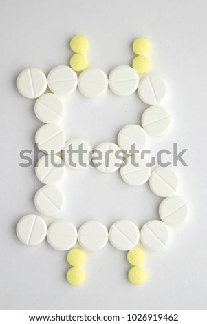 trade in narcotic drugs with the help of cryptocurrency: bitcoin Sign is depicted with pills on white background