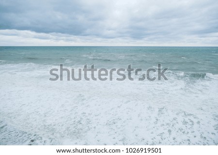 View of storm seascape. Grey clouds, sea foam