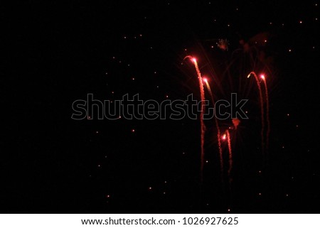 Fireworks Background - A Celebration of Holiday and Independence Day festivities.  New Year's colors of the night through explosions of colorful sparks.  Mankind beautifies the night skies with color.