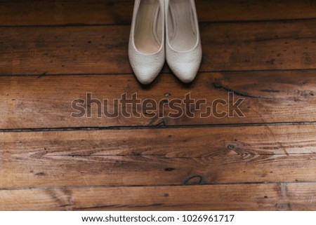 white shoes on a brown background