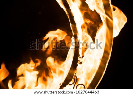 Beautiful flames, on a decorative grille, in the dark