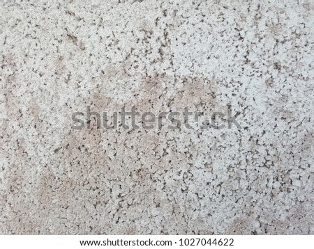 Gray concrete background made of patterned mortar.