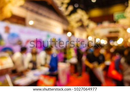 Abstrct blur crowd people walking in trade fair expo in exhibition hall