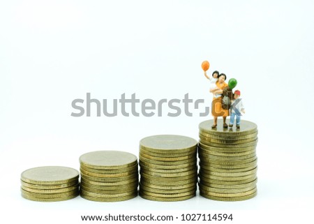 Miniature People : Family standing on increasing stack of coins use as business and finance , saving for child concept.