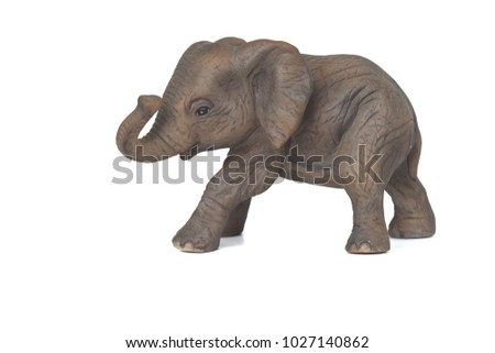 Small cute baby elephant toy on white background