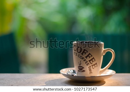 A cup of hot coffee with a good smell of caffeine. Green background