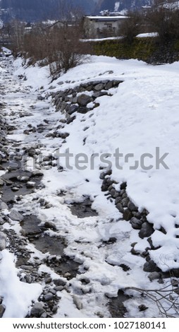Schwaz Tyrol Austria - water channel, creek  - in winter with snow and ice