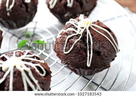 Tasty chocolate cupcakes on cooling rack