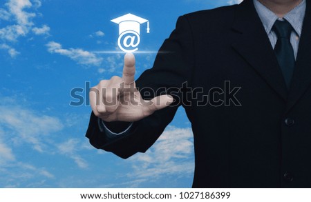 Businessman pressing e-learning icon over blue sky with white clouds, Study online concept