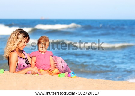 Mother and daughter on the banks of the sea