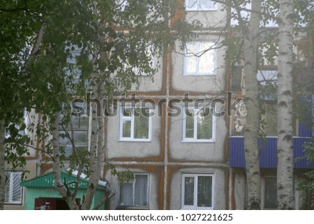 Walls of apartment buildings with windows. Summer and autumn background 