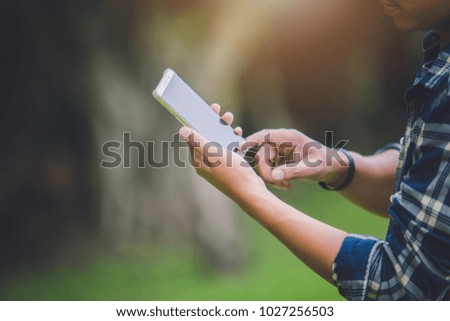 Business man using smart phones in the outdoors.