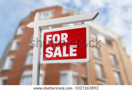 Sign FOR SALE in front of modern apartment house outdoors. Real estate market