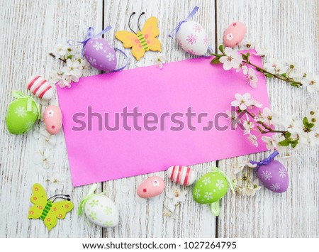 Easter eggs and greeting card on a old wooden background