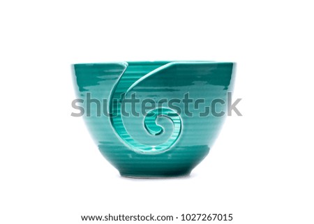 Blue vase isolated on white background. There is a symbol on it.